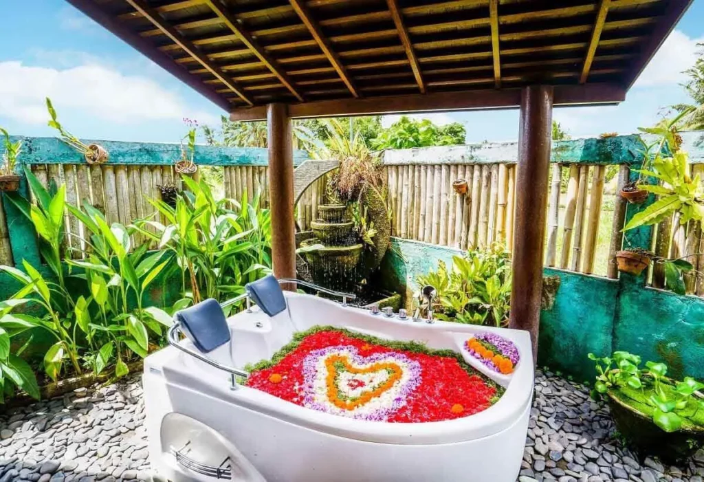 Couple's bathtub beautifully decorated with an array of colorful flower petals