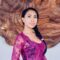 girl with traditional dress in front of giant wood furniture