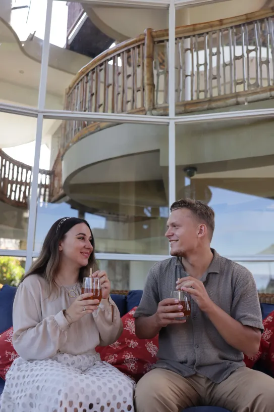 a happy couple get welcome drink