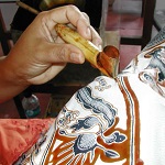 Participants learning the art of batik in a creative workshop
