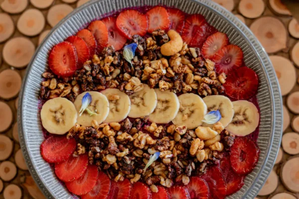 Pancakes with strawberries and bananas and sprinkled with natural seeds