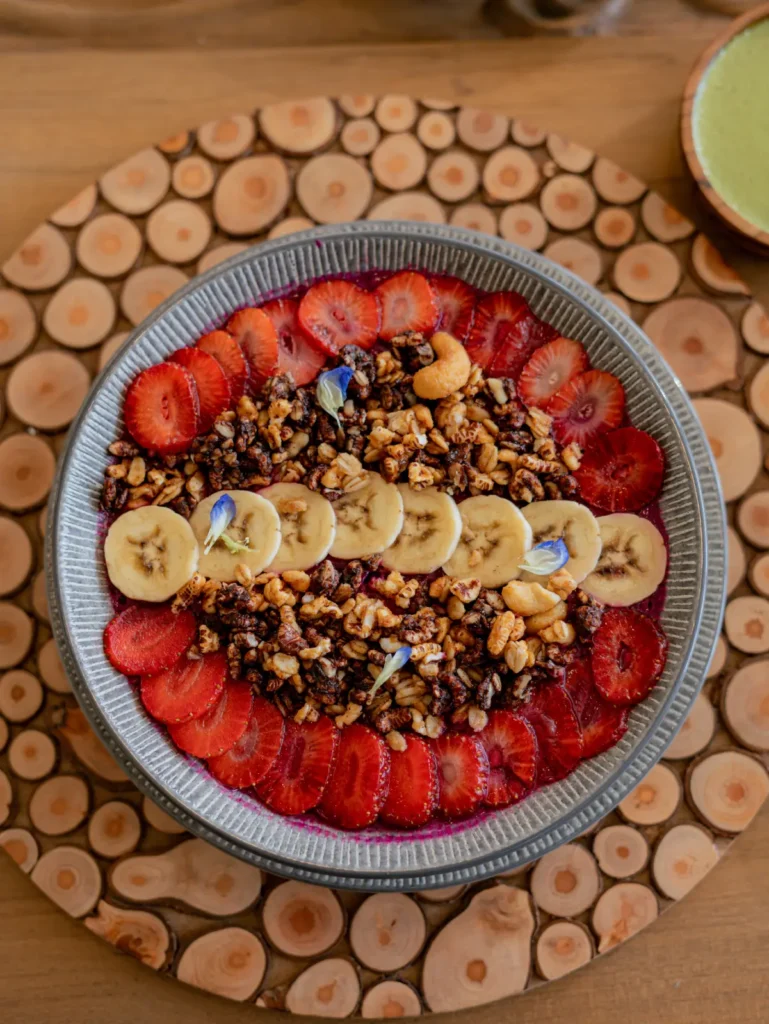 Pancakes with strawberries and bananas and sprinkled with natural seeds