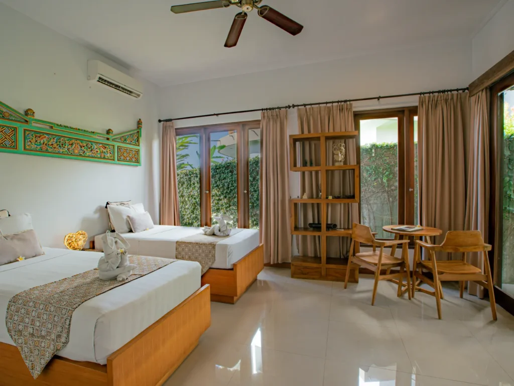 Bedroom on garden room in harmonize Balinese antiques with modern eco-conscious comfort