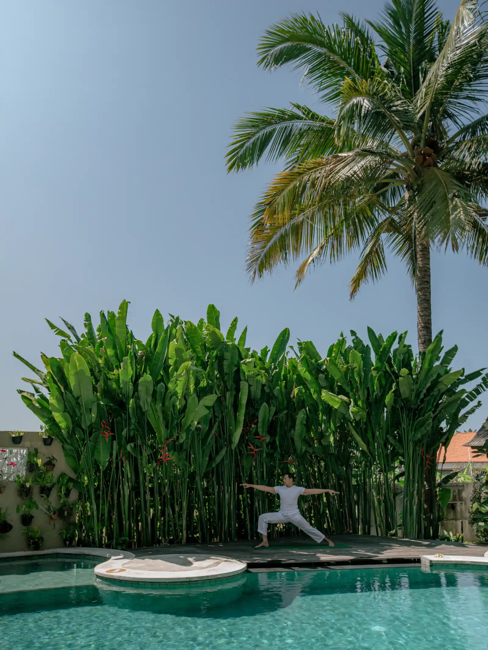 Yoga session taking place beside a serene pool