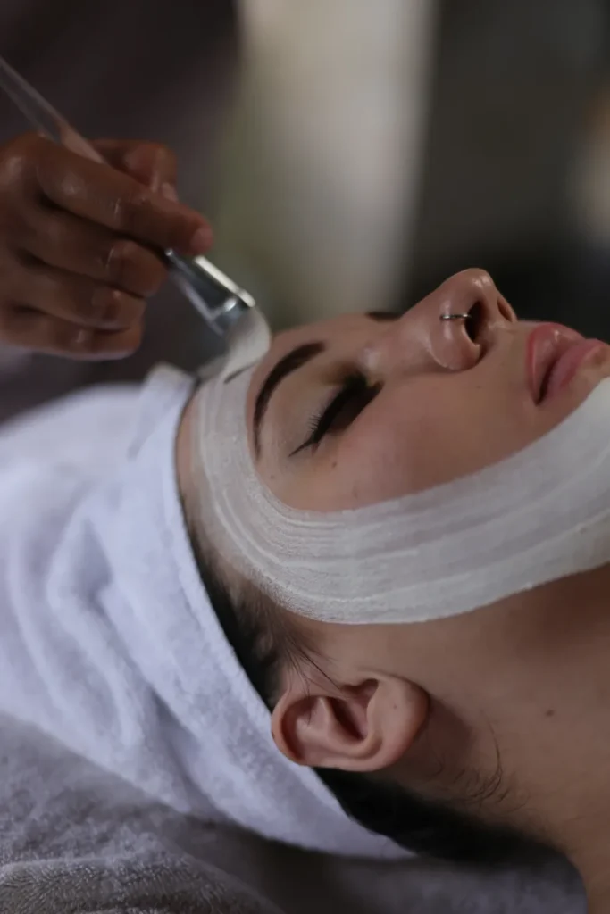 person’s face being gently applied with a facial mask